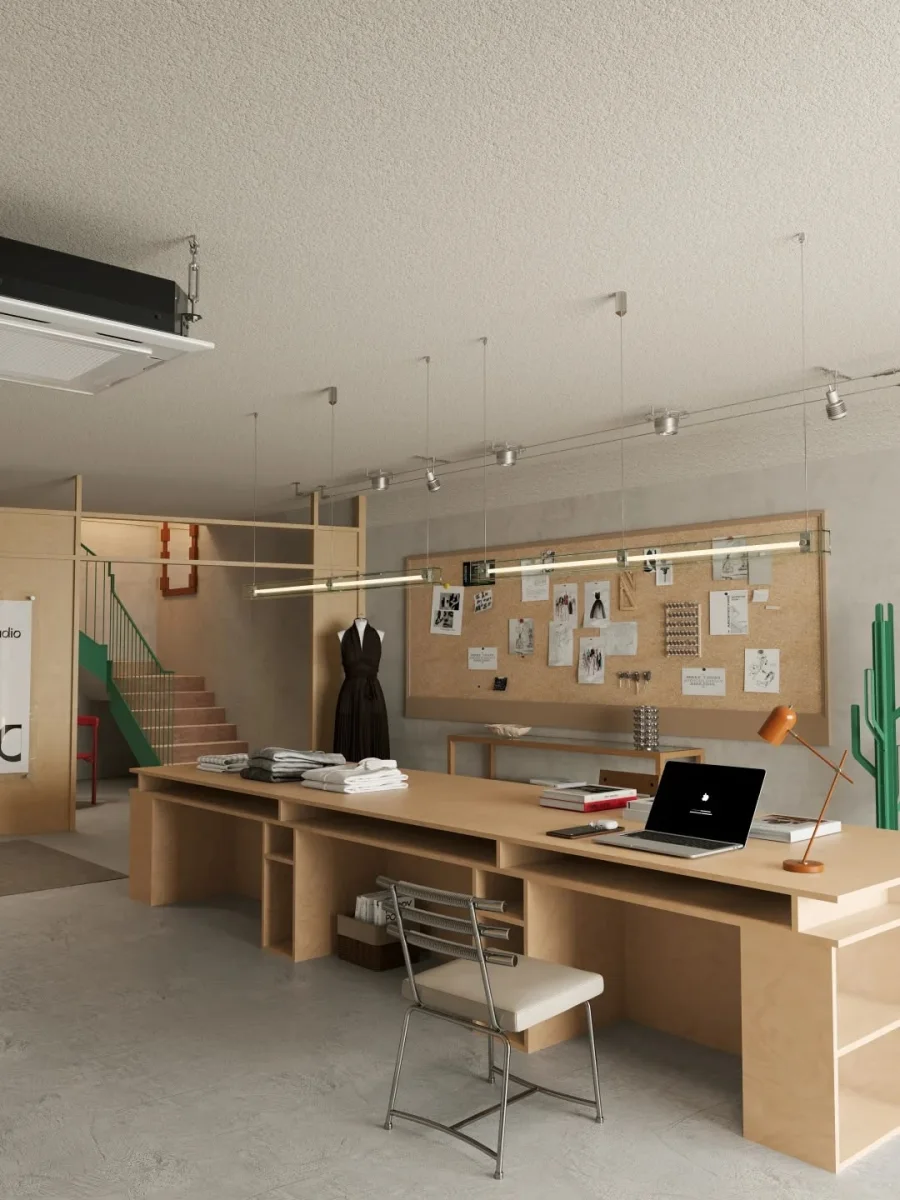 Apparel studio with a large shared worktable and garment display
