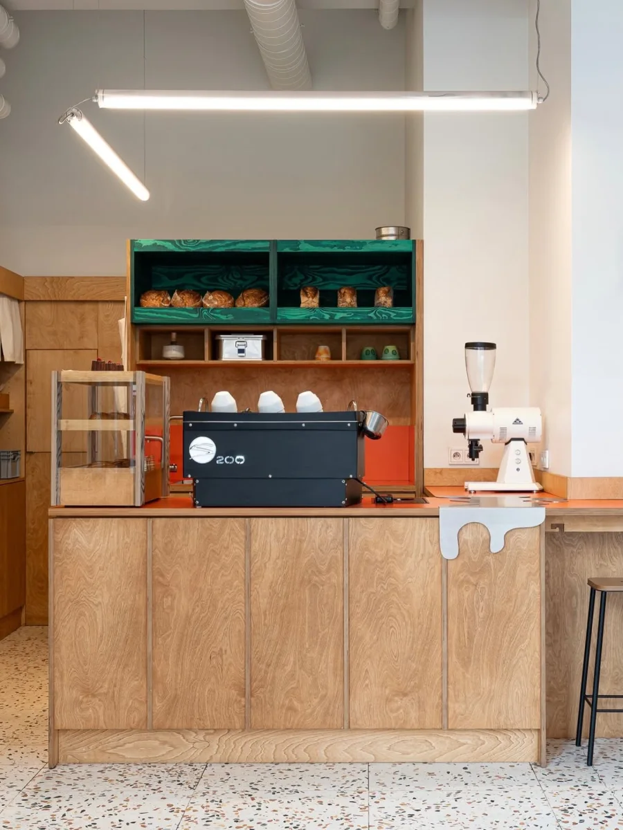 Café counter with coffee equipment and warm timber cabinetry
