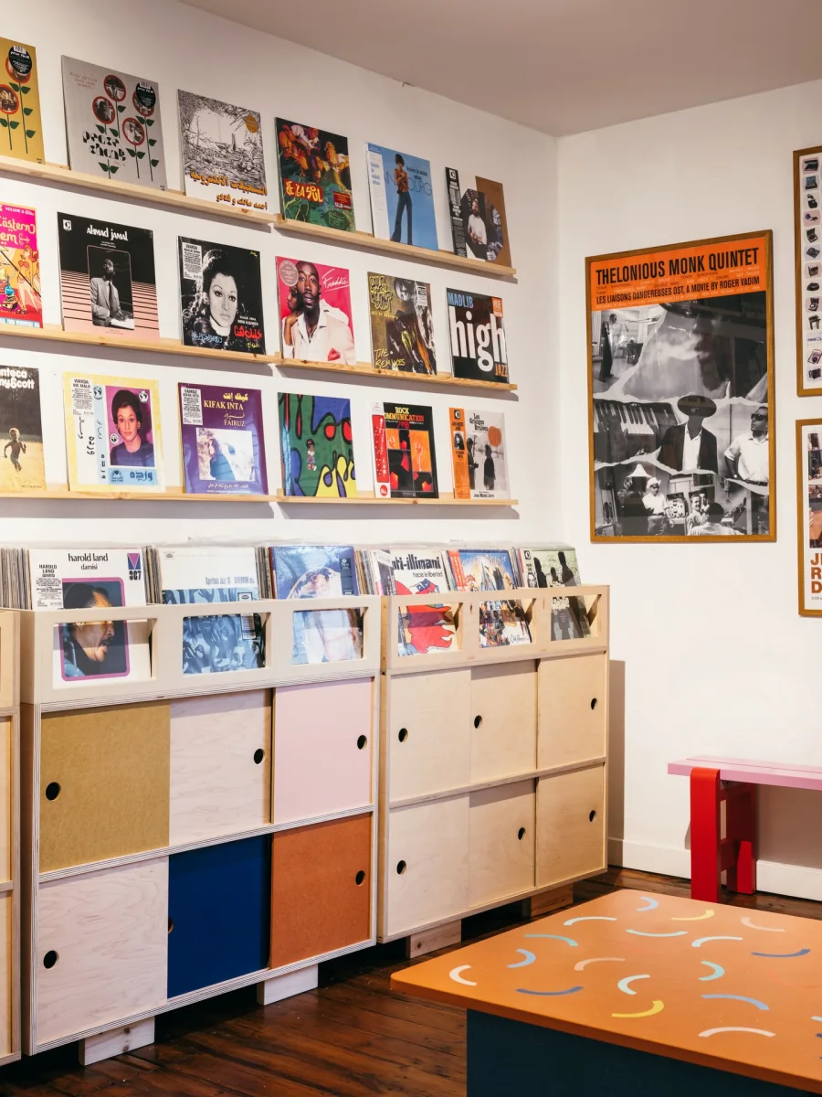 Record shop wall with album covers and record storage cabinets