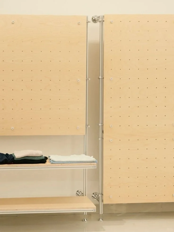 Plywood pegboard wall and clothing display shelves
