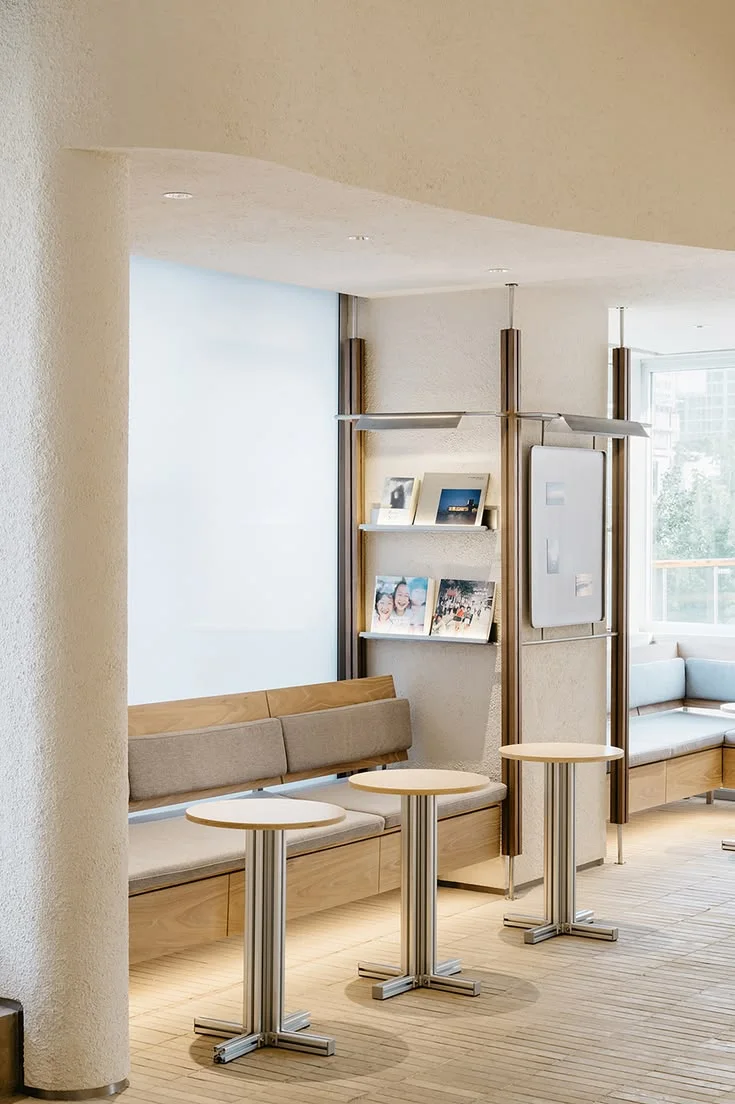 Bright showroom lounge with display shelves and seating